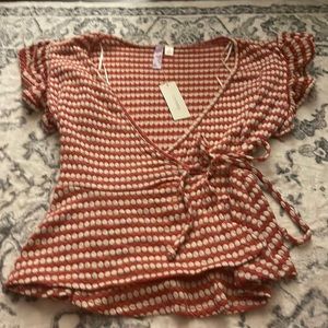 Francesca’s rust and white polka dot surplice top